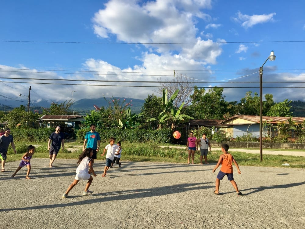 Camp Aftermath volunteers playing soccer with local children in Golfito